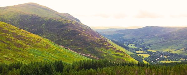 Photo from a peak overlooking Glen Lyon, green forests and valleys